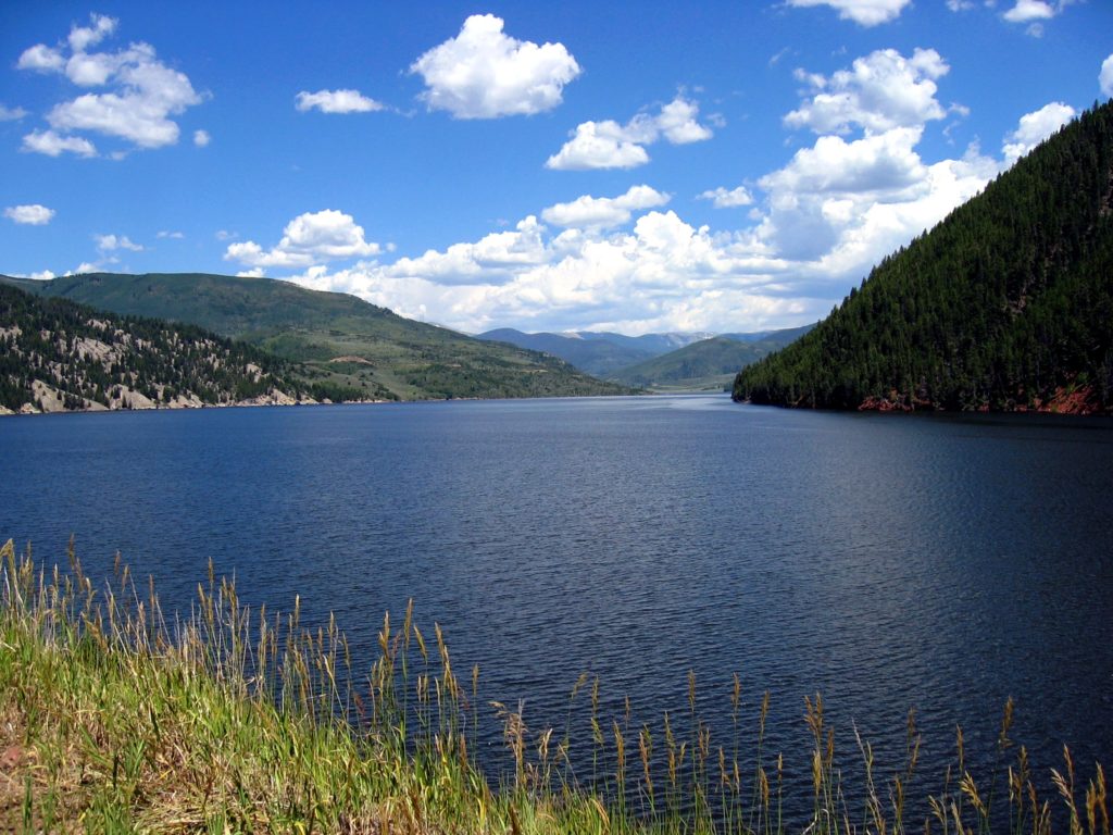 Colorado mountains frame the Ruedi Reservoir on a sunny summer day.